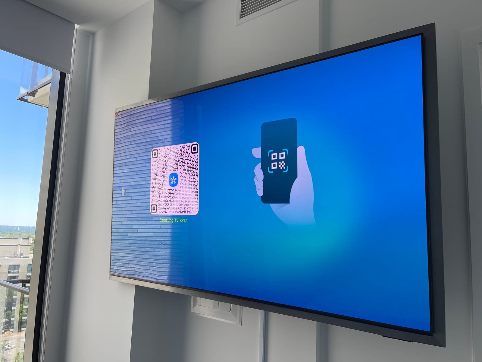Wall-mounted television in a bright condo room